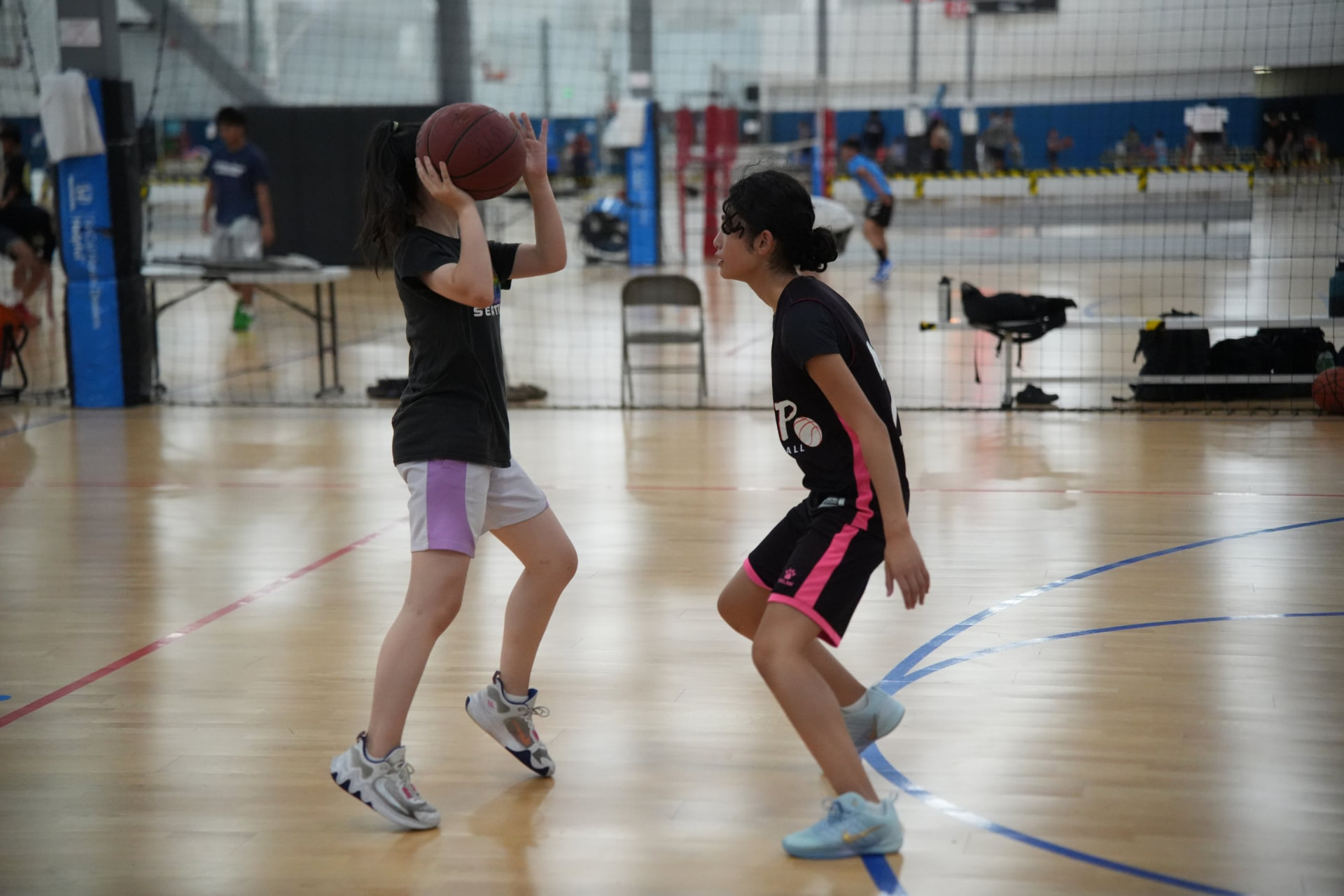 Girls basketball players in UYP jerseys practicing at Momentous Sports Center in Irvine